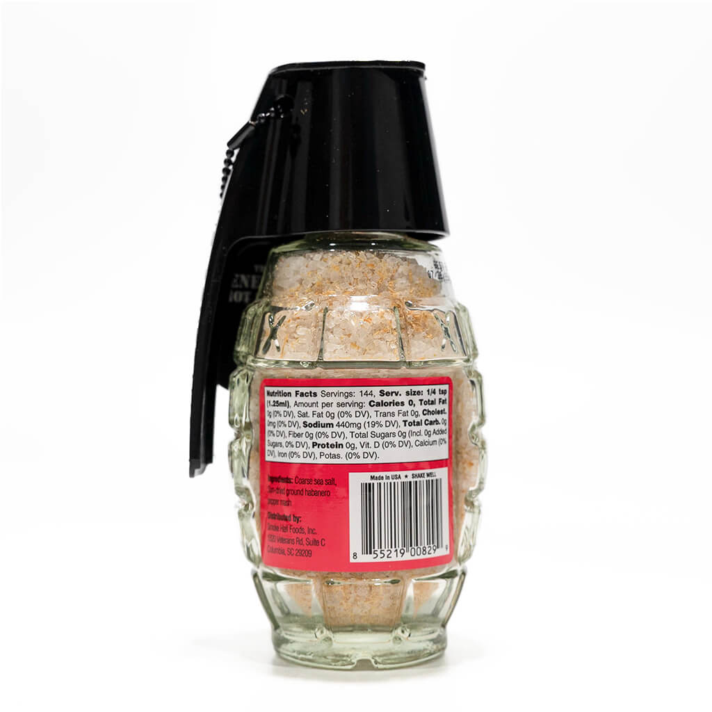 Rear view of a grenade-shaped glass salt container highlighting the nutrition facts label, emphasizing its natural ingredients and 'Made in the USA' stamp.