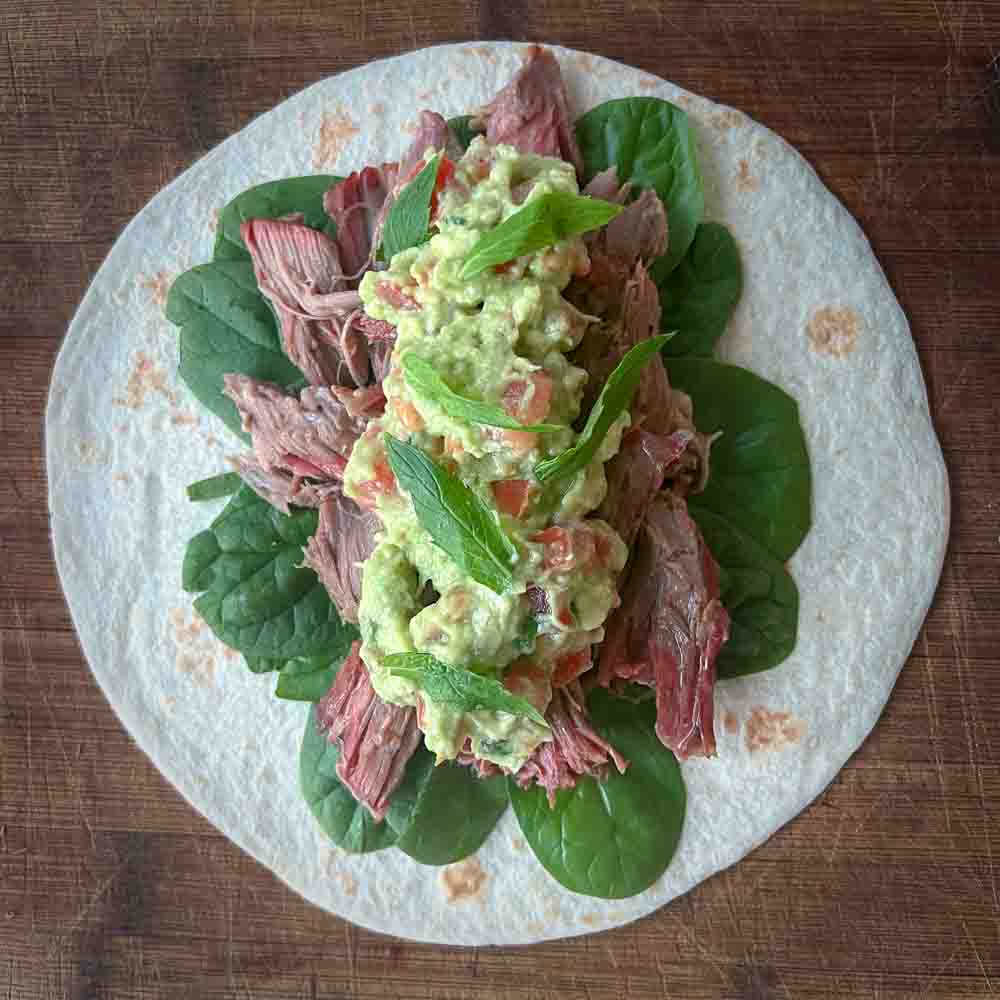 BBQ Smoked lamb wraps with baby spinach, avocado, tomato, and mint filling