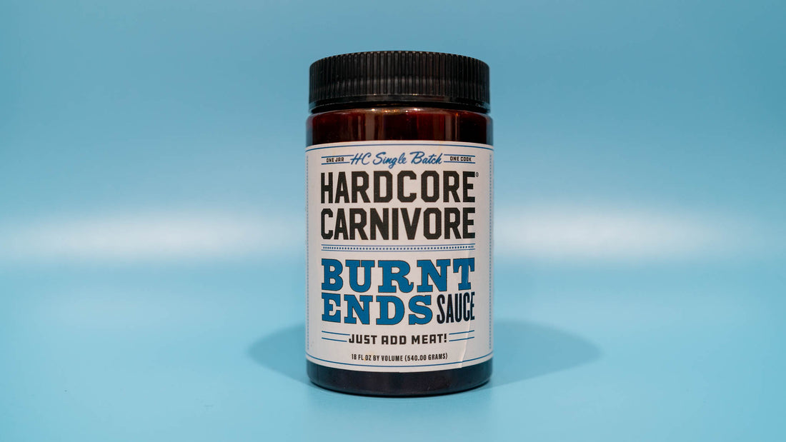 Bottle of BBQ sauce with the label "Hardcore Carnivore Burnt Ends Sauce". Perfect for adding flavor to your low and slow BBQ meat, such as brisket burnt ends.