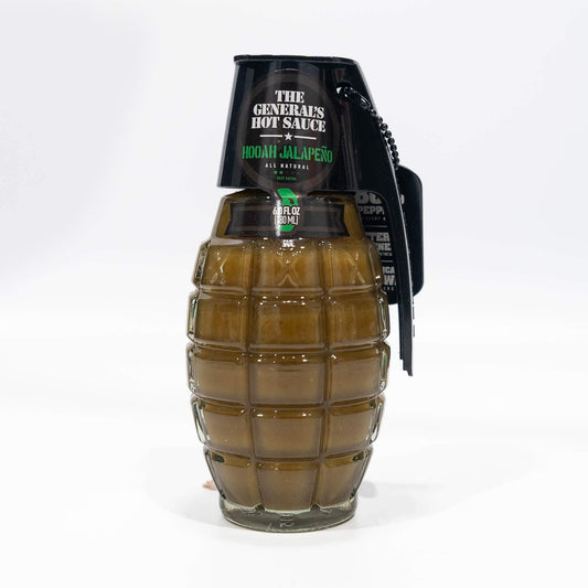Direct front view of The General's Hooah Jalapeño hot sauce bottle with clear visibility of the product name, all-natural claim, and 6 fl oz volume, alongside the distinctive grenade-like bottle design.