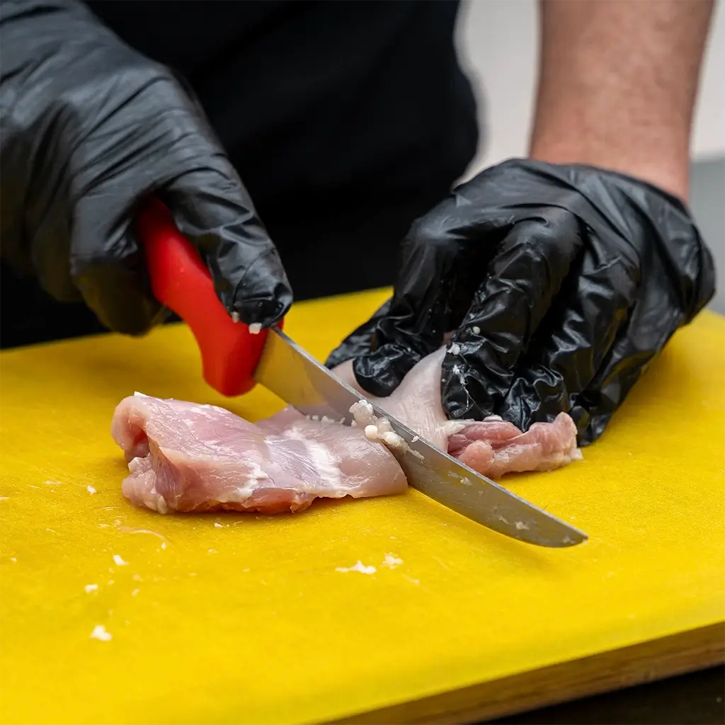 Tramontina Butchers Knife cutting chicken
